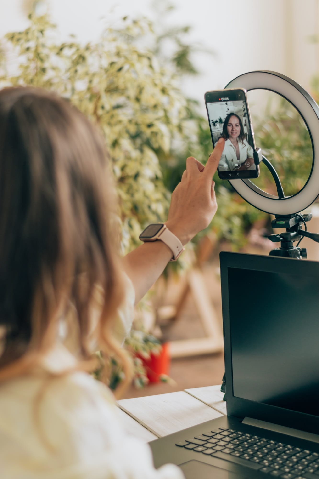 A young woman influencer leads a live broadcast in social media.